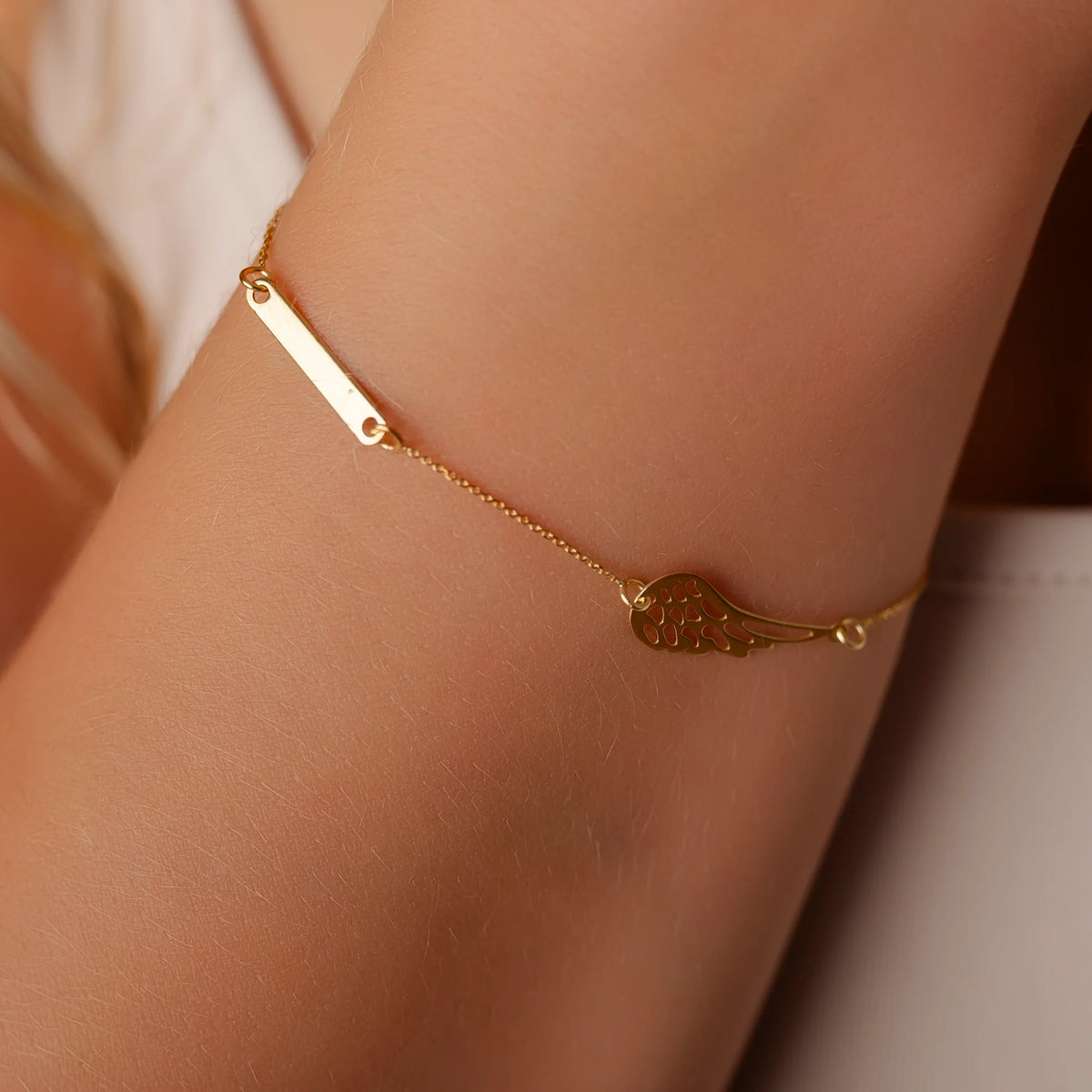Women's Gold Bracelet with Wing and Tag