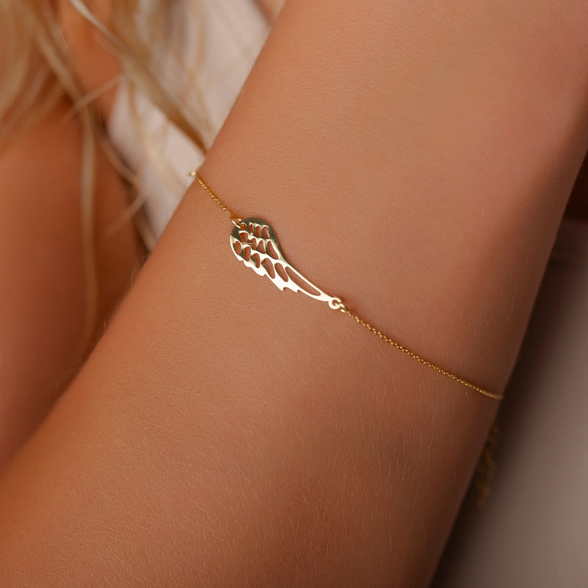 Women's Gold Bracelet with Wing and Tag