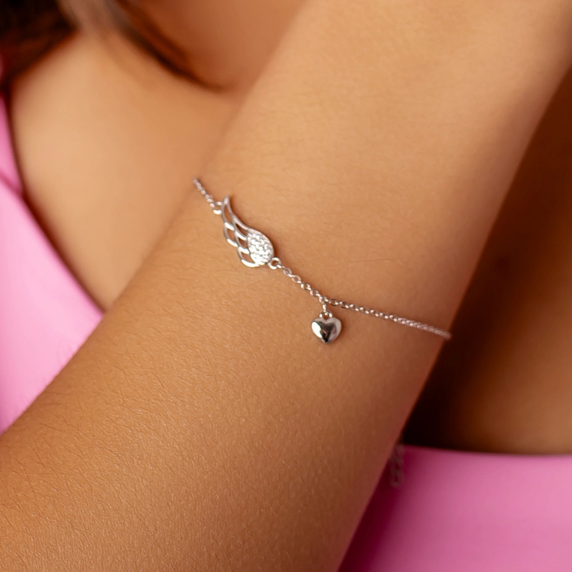 Silberarmband mit Strassflügel und Herz
