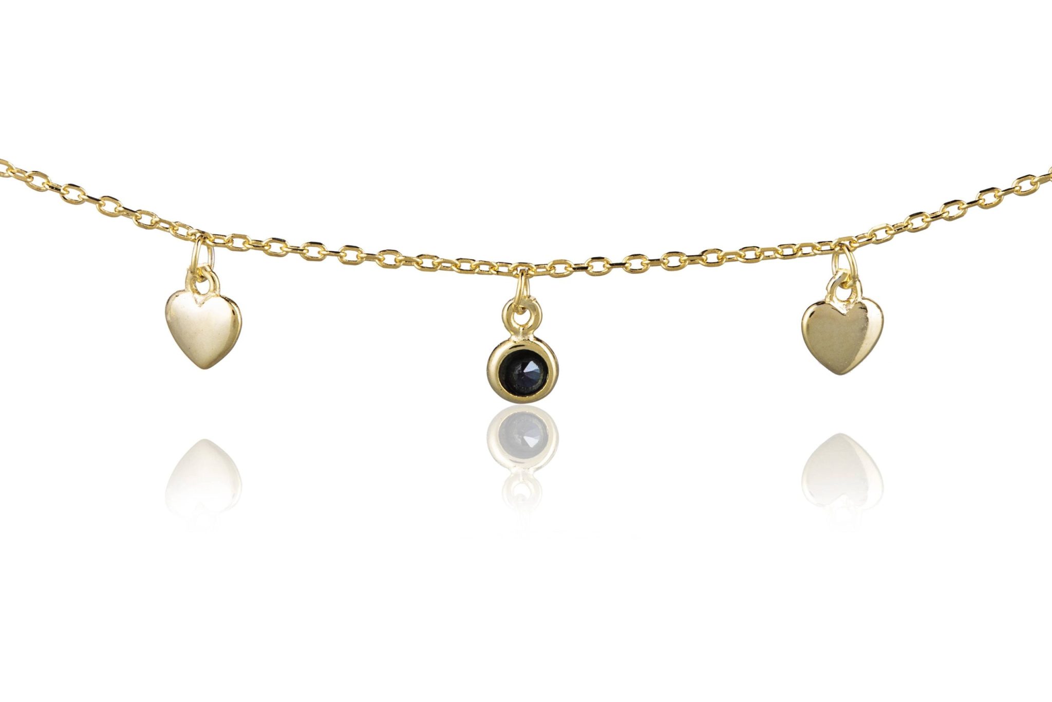 Pulsera de plata dorada con corazones y puntos de luz negros
