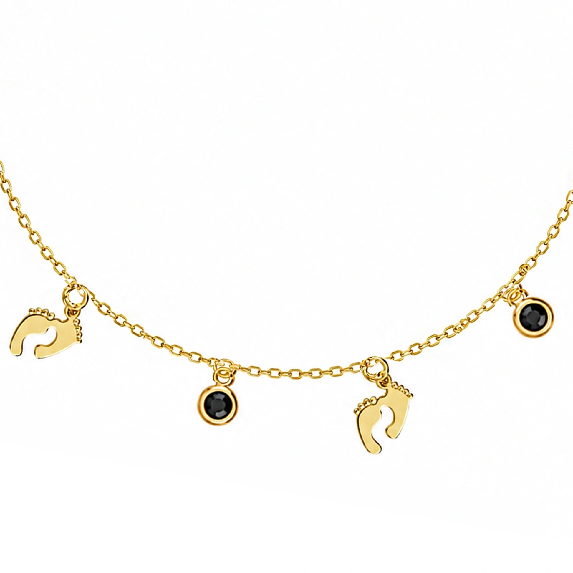 Pulsera de plata dorada con piecitos y punto de luz